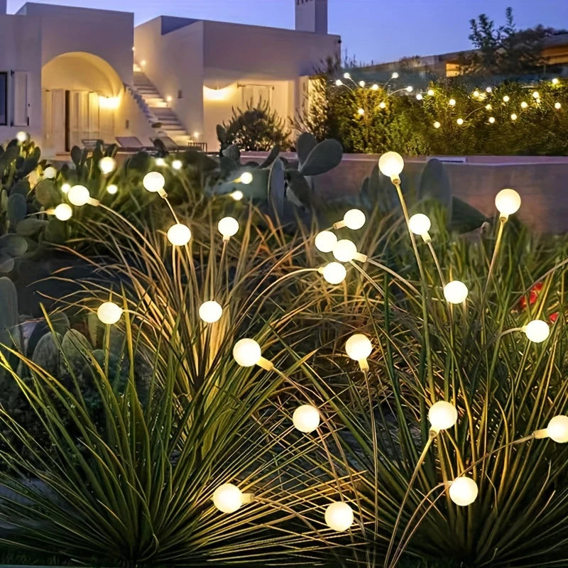Solar firefly lights along a house walkway